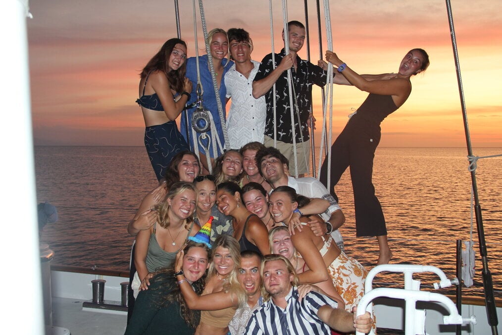 Sail volunteering abroad A group of friends on a boat during sunset
