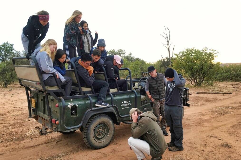 A group of students on a truck in the wilderness