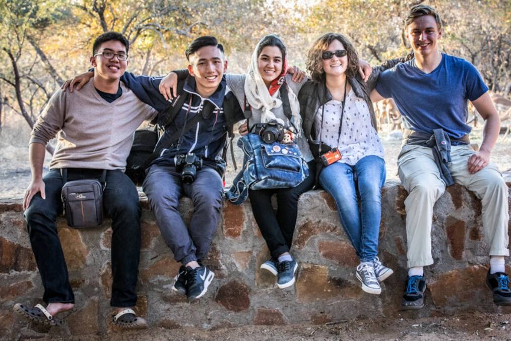 A group of friends sat on a wall
