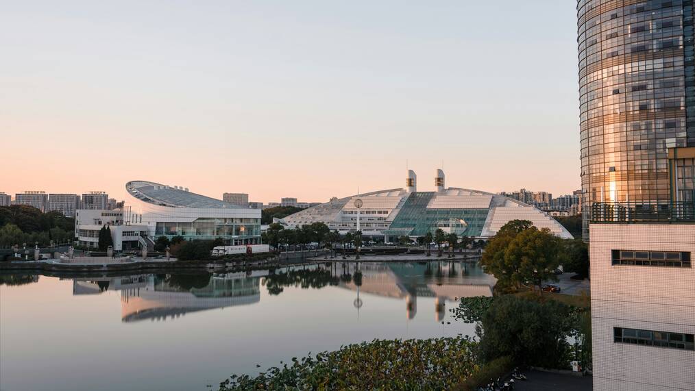 A view of a lake in front of the Zhejiang University campus at sunset.