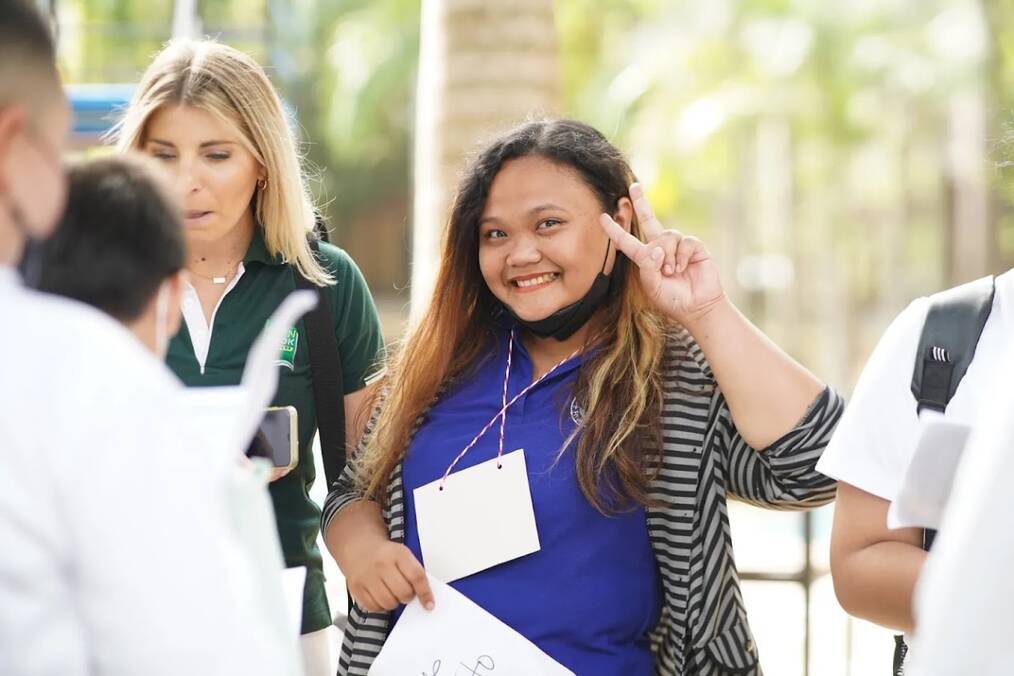 A teacher doing the peace sign 