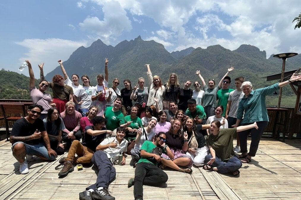 Volunteer abroad A large group of people posing in a mountainous location