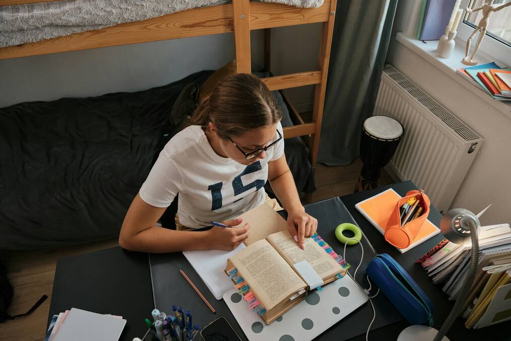 A girl studying in her dorm room