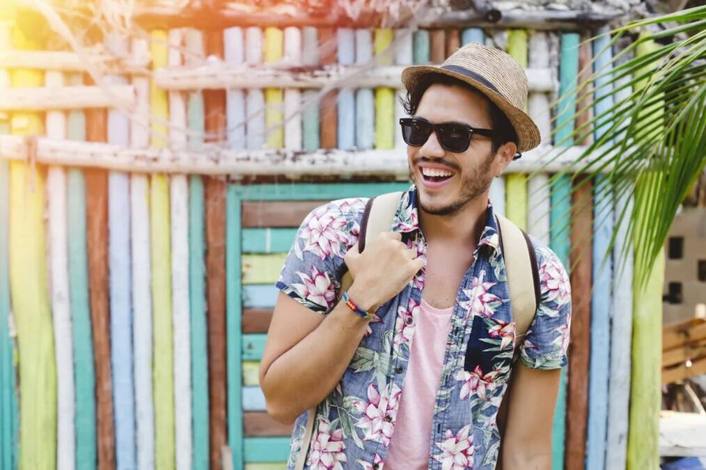 A person wearing a floral shirt and sunglasses
