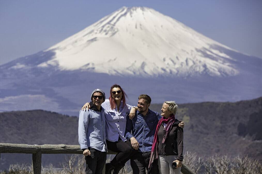 A group of friends standing in front of Mt. Fuji in Japan