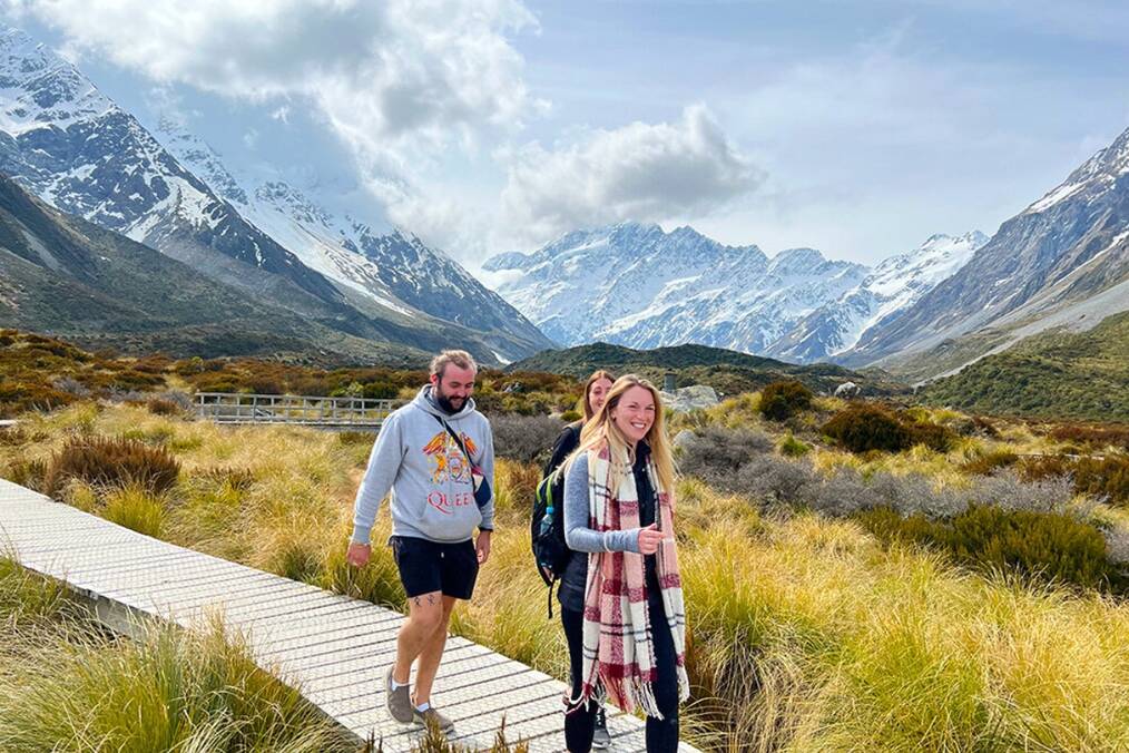 A group of people walking through a mountainous landscape