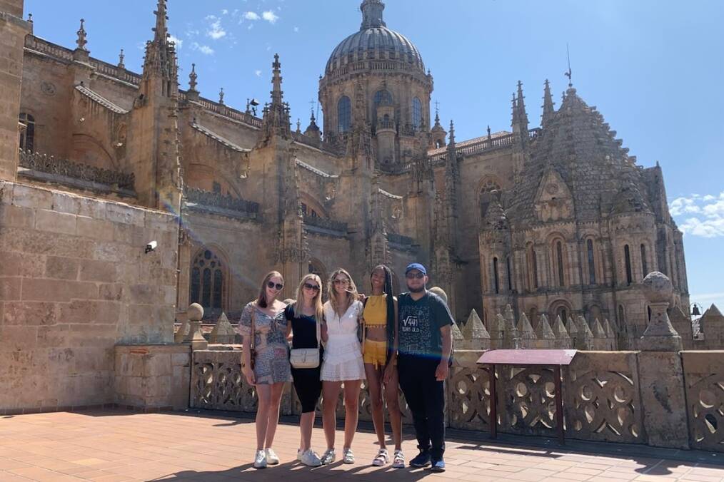A group of people standing in front of a Cathedral