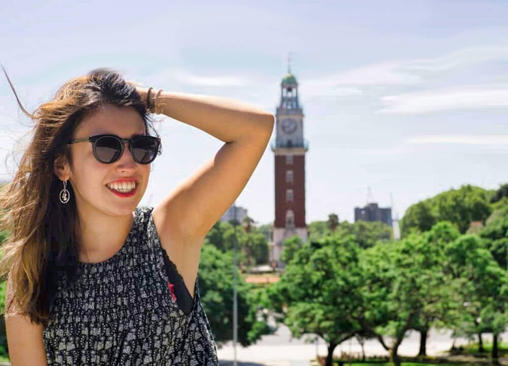 A person with sunglasses posing in front of a tower in Argentina