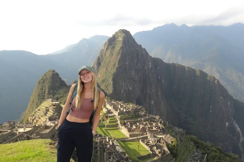 A person standing in front of Machu Picchu