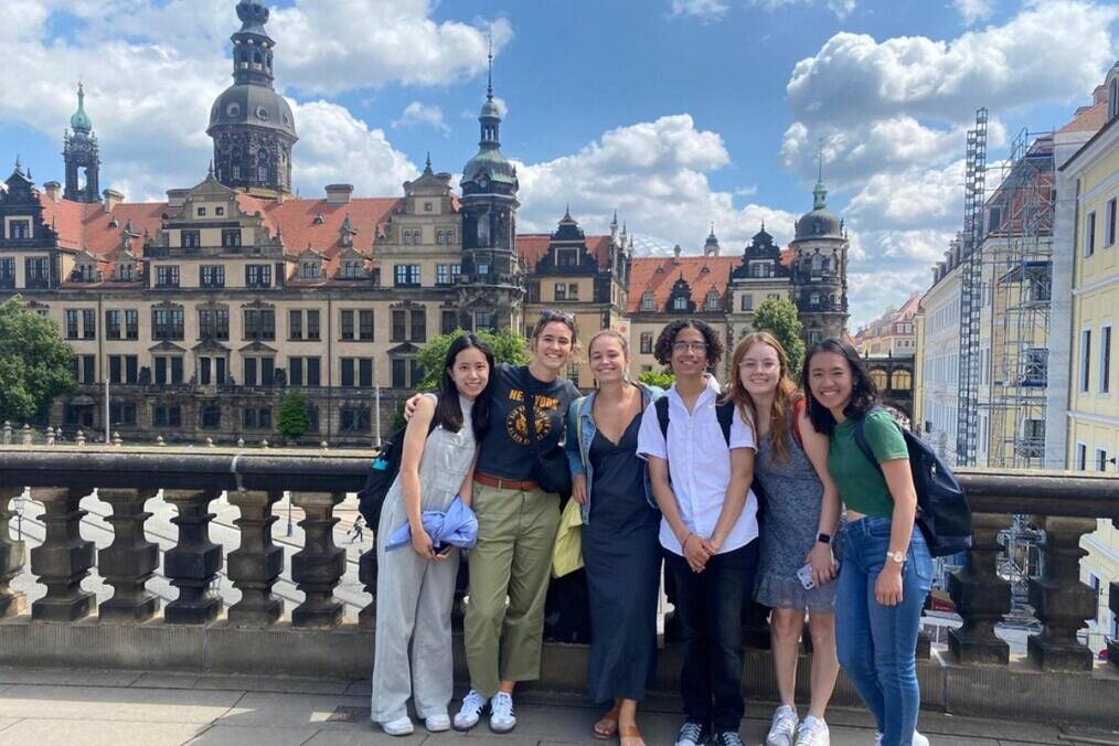 A group of friends posing in front of German architecture 