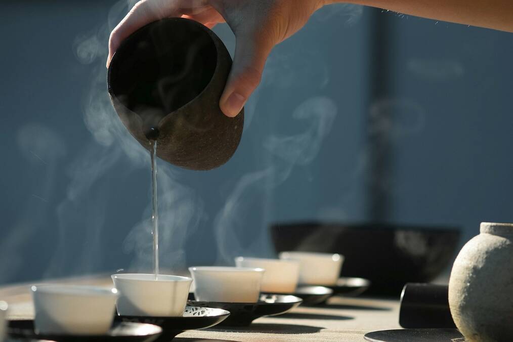 Tea being poured into small cups
