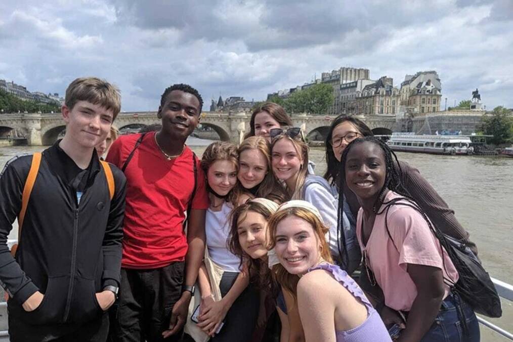Teens on a boat on the river.