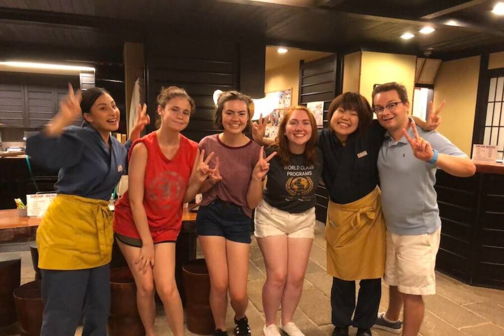 Girls pose in a Japanese restaurant.