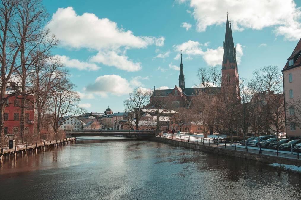 A cathedral next to a body of water on a sunny day
