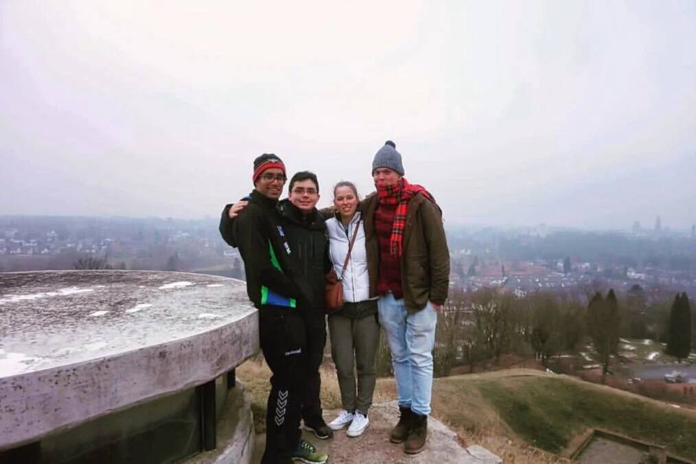 A group of people standing on a hill overlooking a town