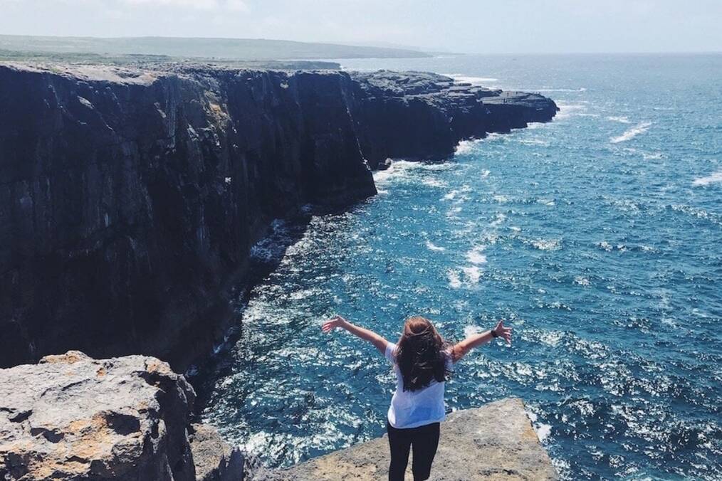 A person on the Irish coast staring out to sea