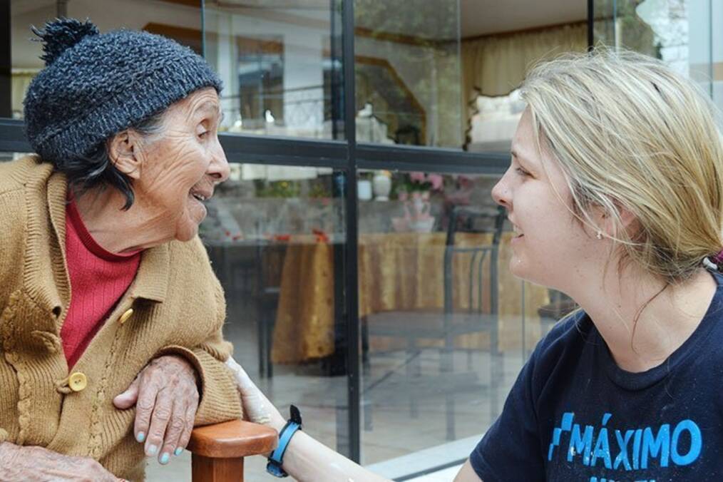 A volunteer talking to an elderly person