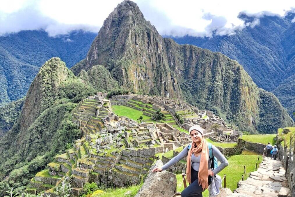 A person posing near Machu Picchu in Peru
