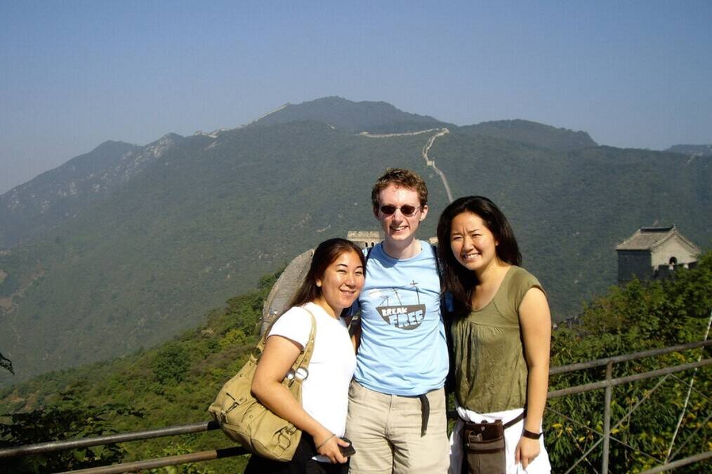 Three people standing on the Great Wall of China