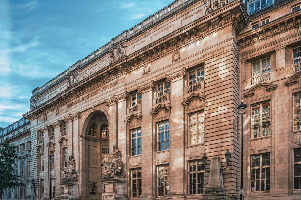 A university building with cars parked in front