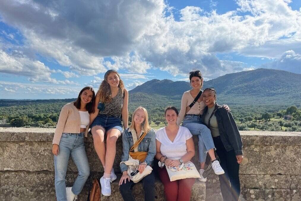 A group of friends in front of a scenic backdrop