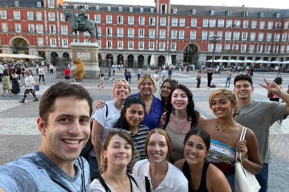 A group of friends taking a selfie in Plaza Mayor, Madrid, Spain