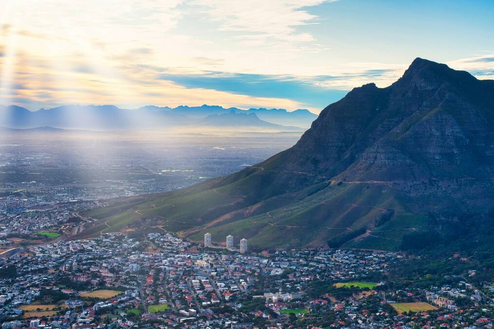 City near mountain under cloudy sky