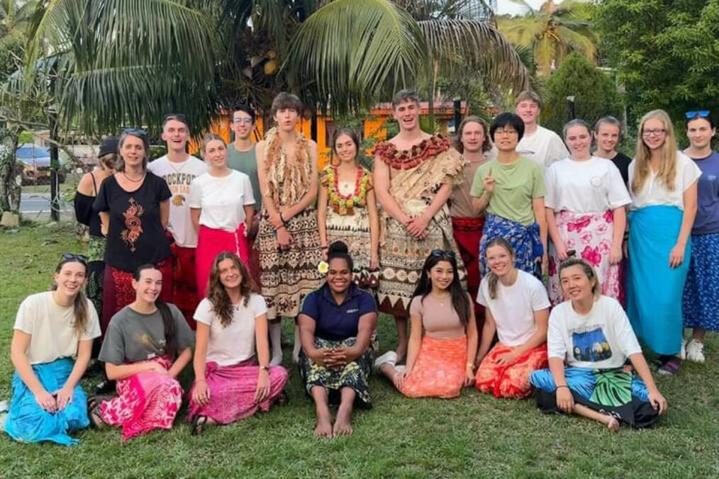 A group of foreigners enjoying cultural traditions in Fiji