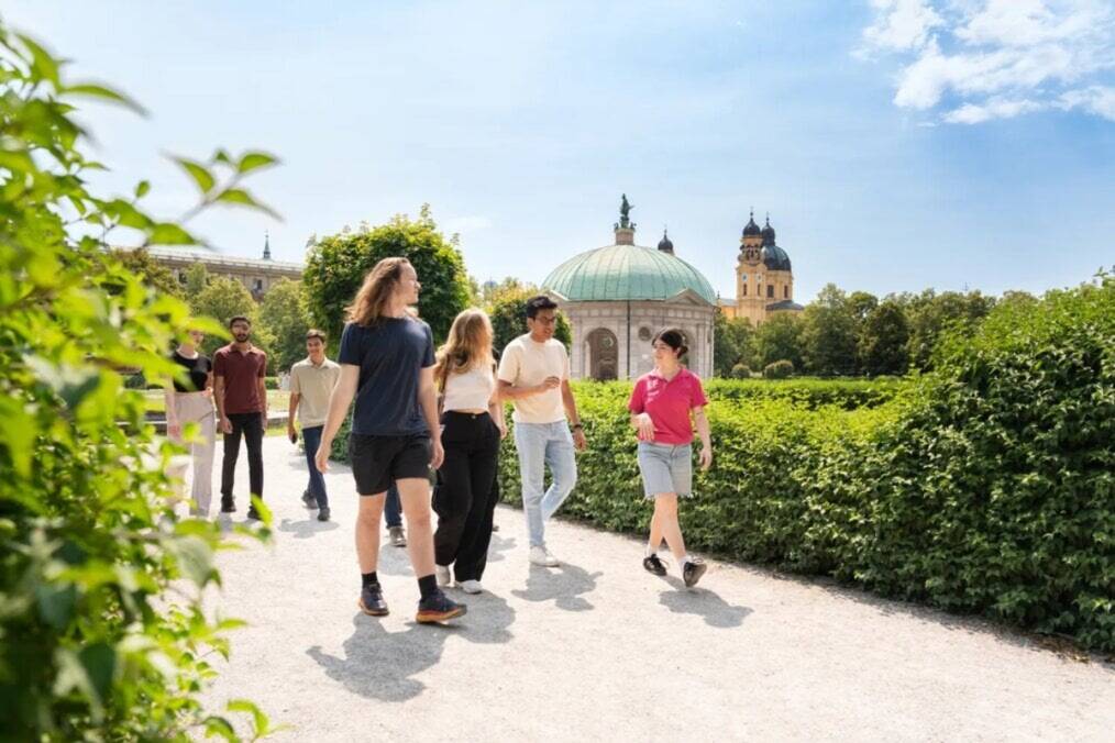A group of students walking down a garden in Germany