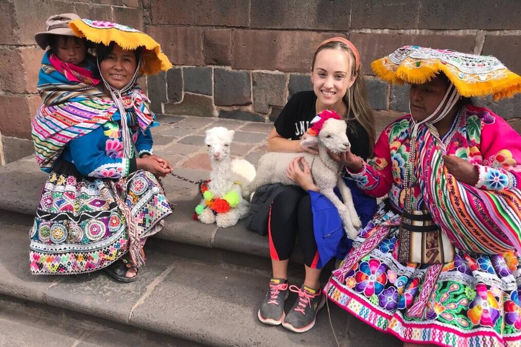 A foreigner integrating with locals in Peruvian dresses