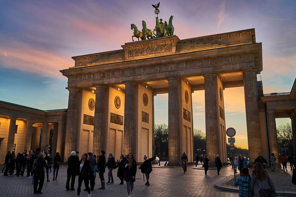 A group of people standing in front of a German monument