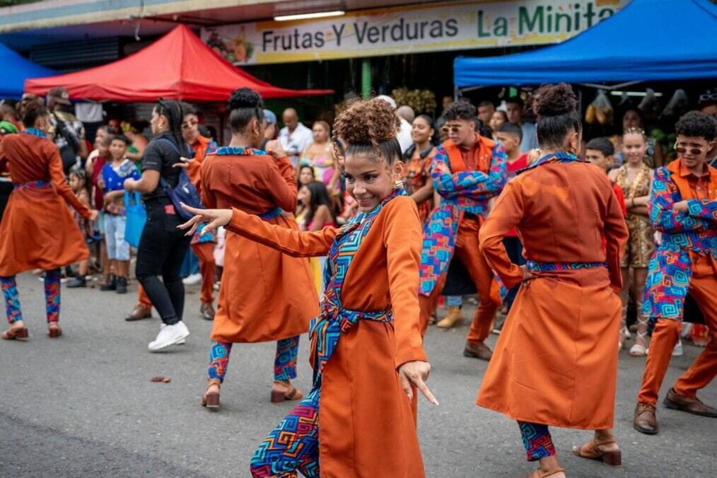 A person in an orange robe dancing