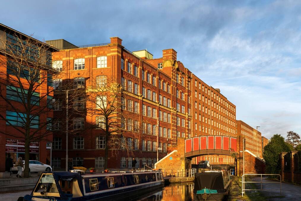A sunlight hitting a canal-side building
