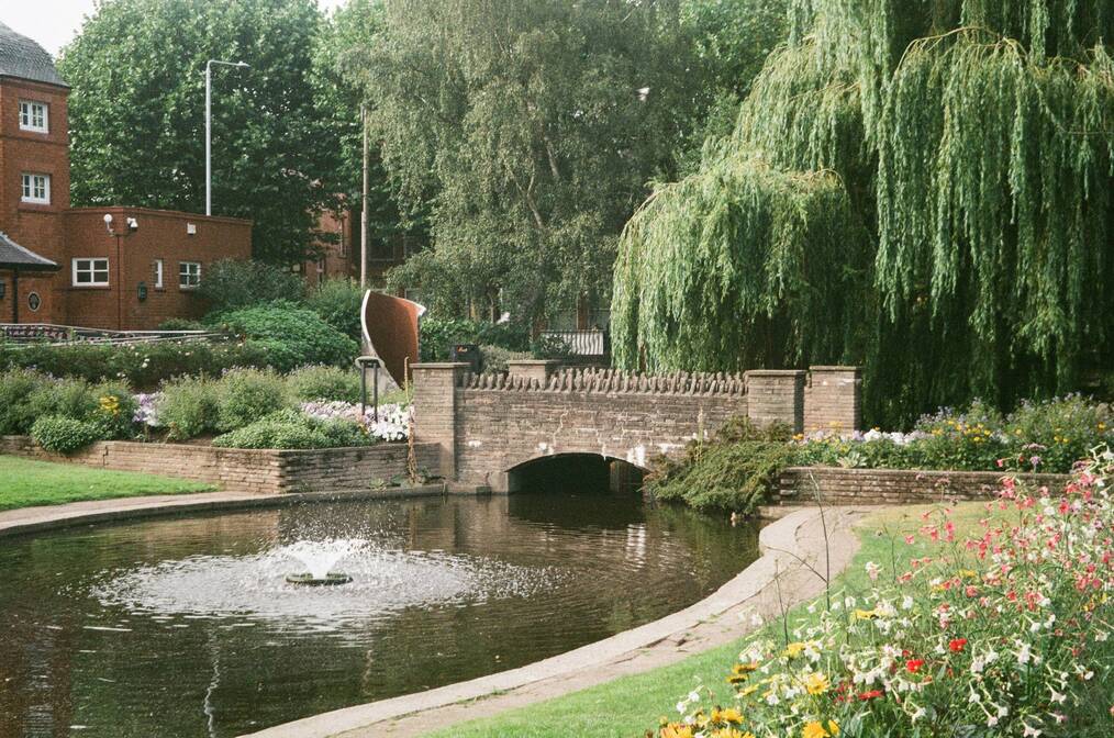 A canal and bridge in a park