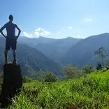 person standing on top of a tall rock