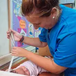 woman nurse working with baby