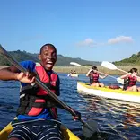 Male student on a kayak living his best life in Cape Town 