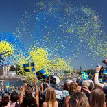 swedish festival with balloons in the air and people celebrating