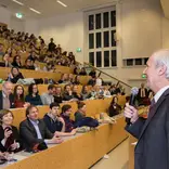 Old man telling something in the stage