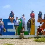 people around a Belize Sign