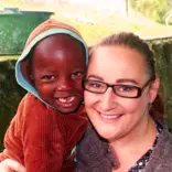 Child and Volunteer Smiling 