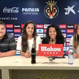 Marketing interns sit at a table with logos behind them