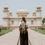 Young woman's back in front of historic Indian building
