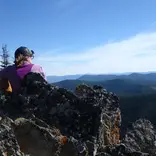 girl on mountaintop overlooking view of mountains in Montana