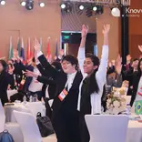 Students wave at aModel G20 Youth Leadership Summit