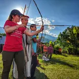Professor Julie Madewell from Indiana University shoots and bow and arrow
