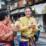 Teacher and student laugh in a street festival
