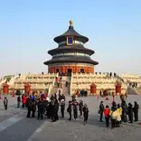 crowd of people standing in front of Chinese temple with 