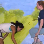 Volunteers decorating class-room walls.