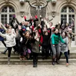 Group of students jumping during trip to Paris
